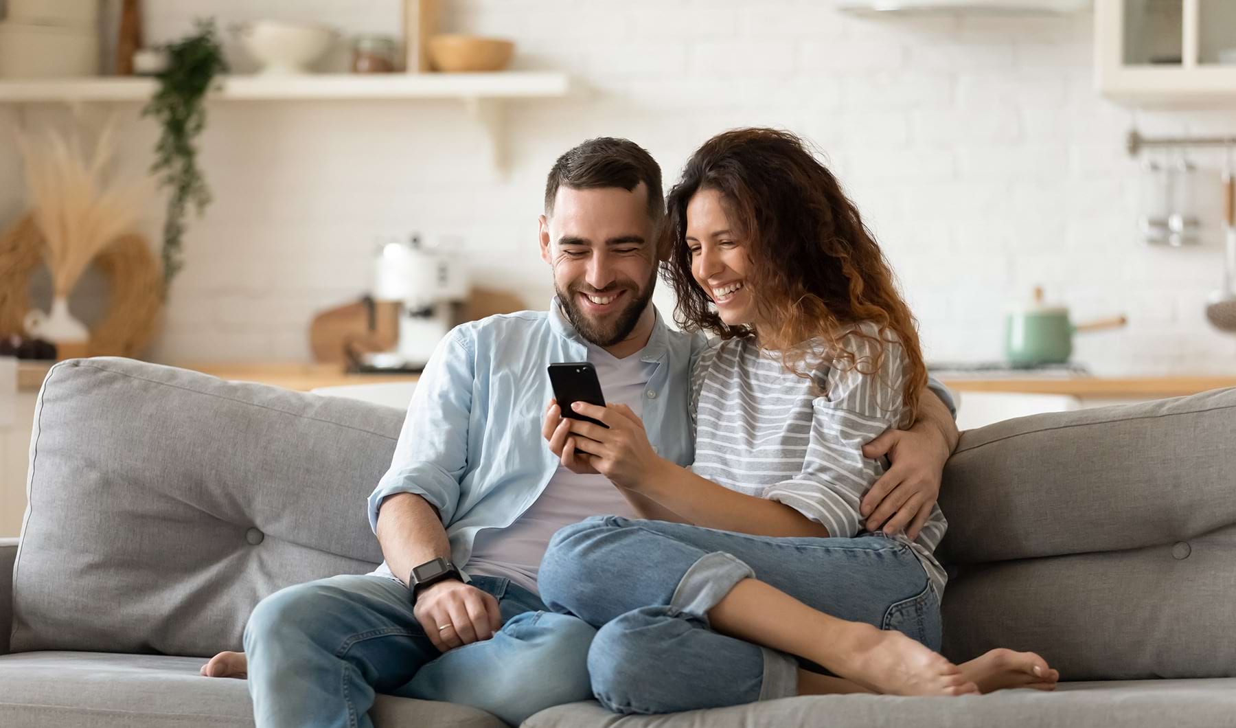 Living Room Spacious and well lit living room with wood flooring, large windows and open access to the kitchen.